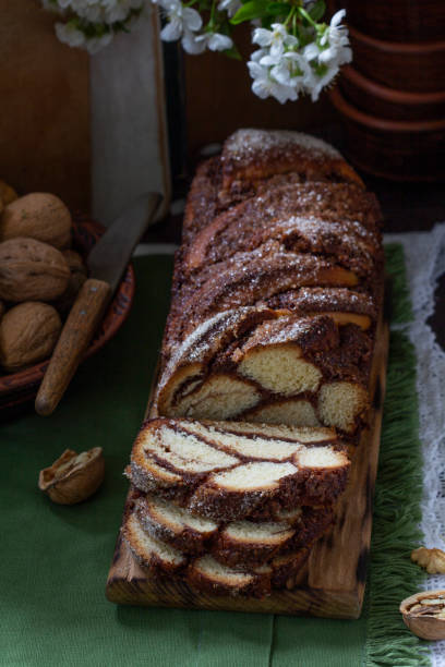istock Traditional Easter bread with chocolate and nut filling on a wooden background. 1468002947