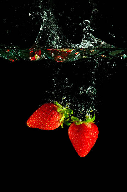 istock Strawberries splashing into water on black 146800645