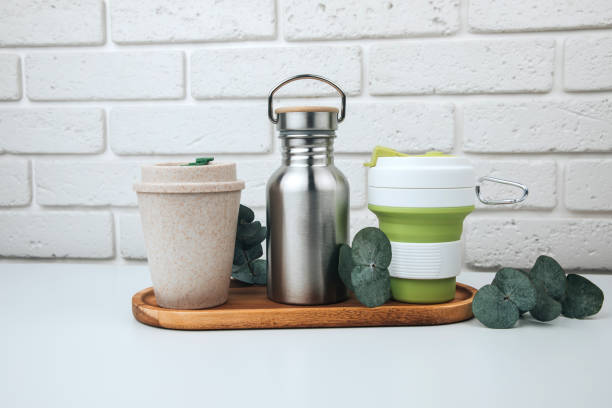 istock Set of devices for cold and hot drinks. Zero waste concept. A tin bottle for water and a mugs for coffee, tea on a wooden handle 1468011511