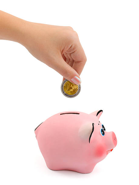 istock Piggy bank and hand with coin 146801275