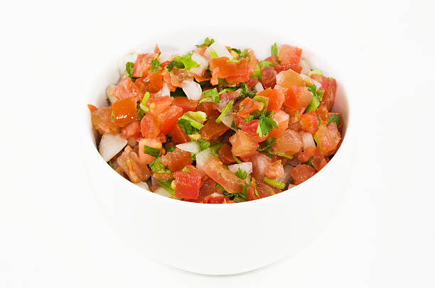 istock A white bowl filled with pico de gallo on a white surface 146801377