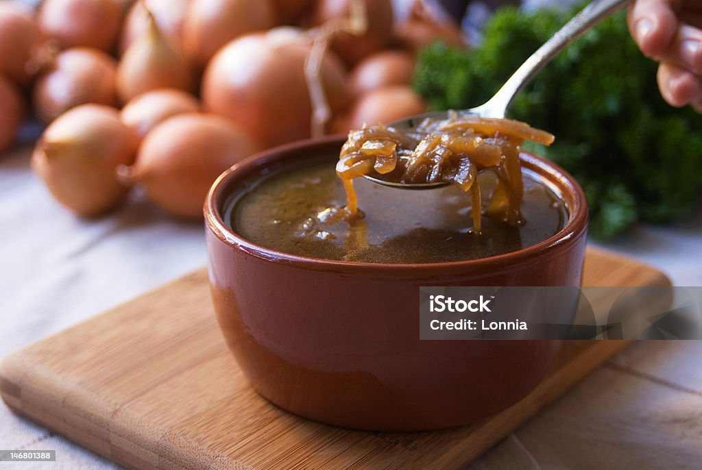 French Onion Soup French Onion Soup in a brown ceramic bowl with ingredients in the background Onion Soup Stock Photo