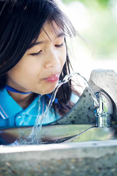 istock Girl drinking from water fountain 146801848