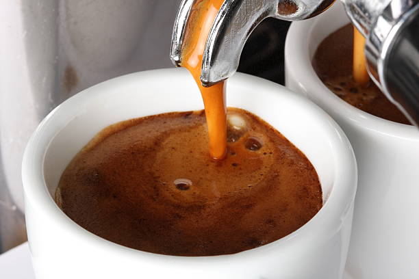 Espresso pouring into a cup stock photo