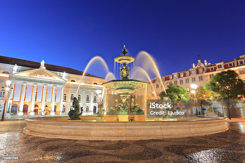 The fountain at Rossio square in Lisbon at sunset Fountain at Rossio square, Lisbon, Portugal Majestic Stock Photo