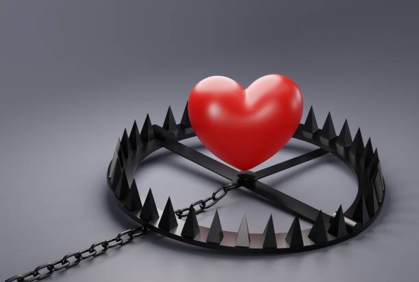 istock Heart over a snare, a trap on a dark background. 1468020931