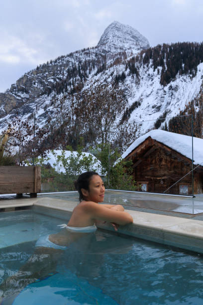 istock Lady inside hot water pool in snowy winter mountain 1468021771