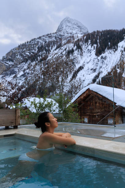 istock Lady inside hot water pool in snowy winter mountain 1468021792