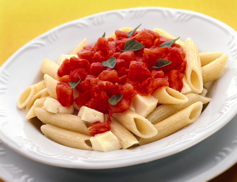 penne with basil and tomato sauce on plate