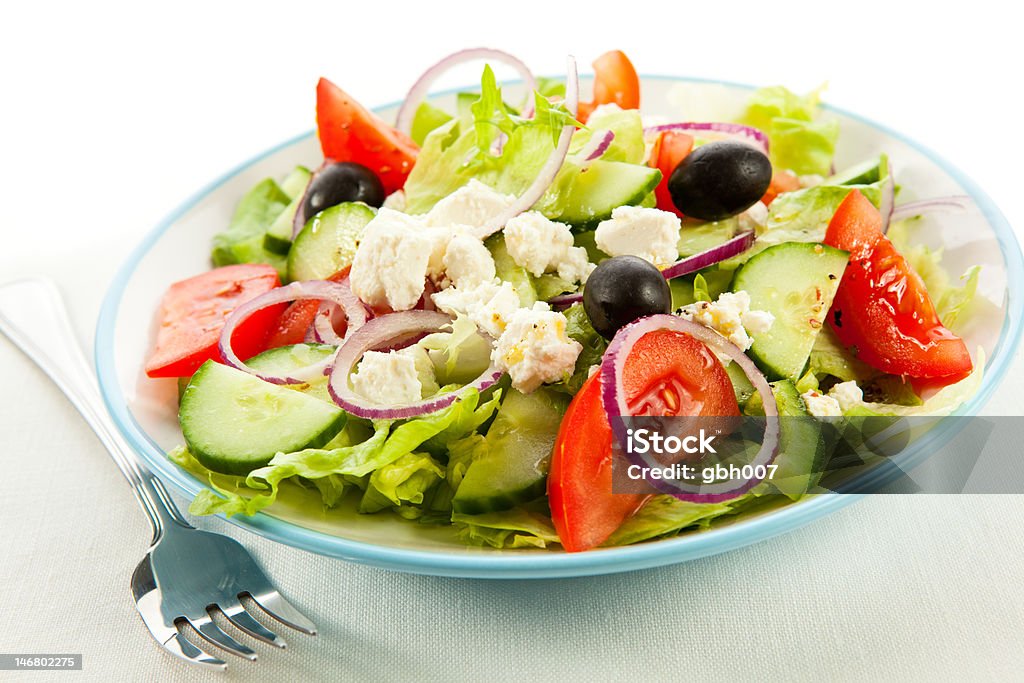 Greek salad Feta cheese with sliced tomatoes , lettuce, cucumber, black olives and onion Appetizer Stock Photo