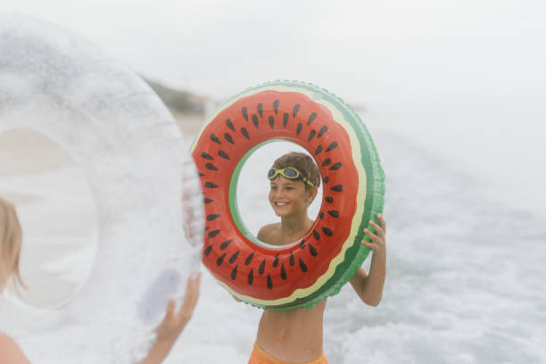 istock Kids having fun by the sea 1468024188