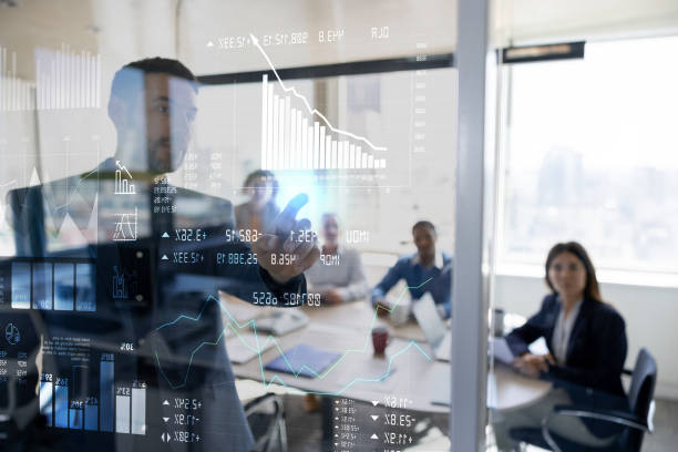 man in a business meeting using an interactive screen while giving a presentation - corporate finance imagens e fotografias de stock