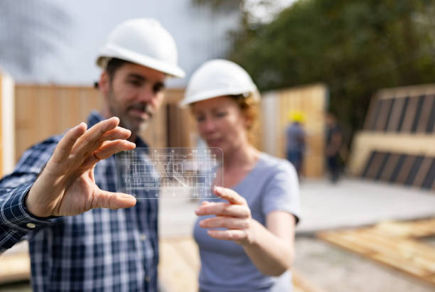 istock Architects looking at the blueprints of a house using an interactive screen 1468025014
