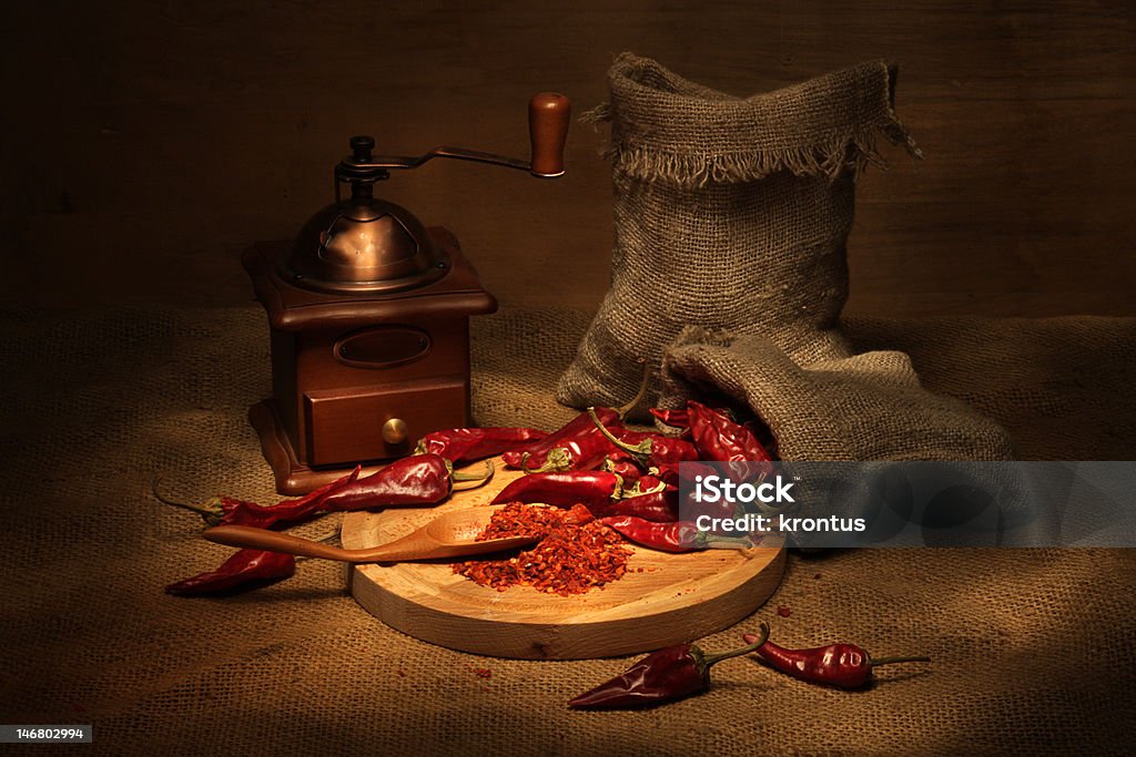 Pepper and handmill Vintage still life with cayenne pepper and handmill Bag Stock Photo