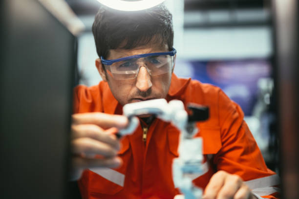 istock Professional technician checking and repairing parts of robotic machine 1468033366