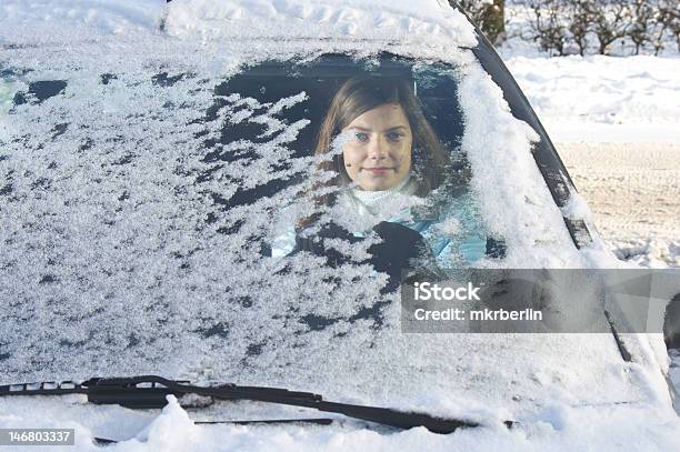 A Woman In Her Car With Snow Covering Her Windshield Stock Photo - Download Image Now