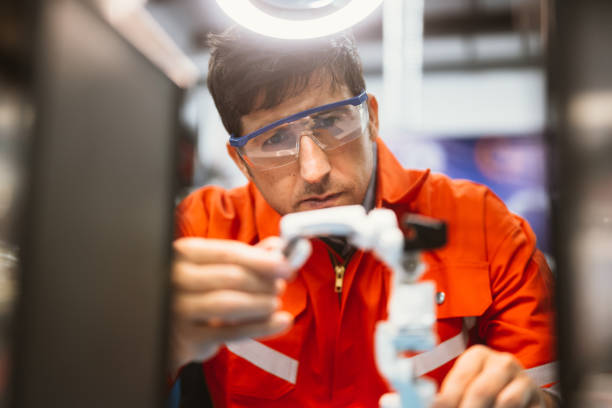 istock Professional technician checking and repairing parts of robotic machine 1468033521