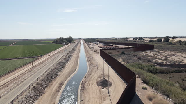 Approaching Movement of Border Wall, Colorado Diversion Dam River Drainage at Barrier Between Yuma Arizona and Algodones, Baja California Norte Mexico on a Sunny Day