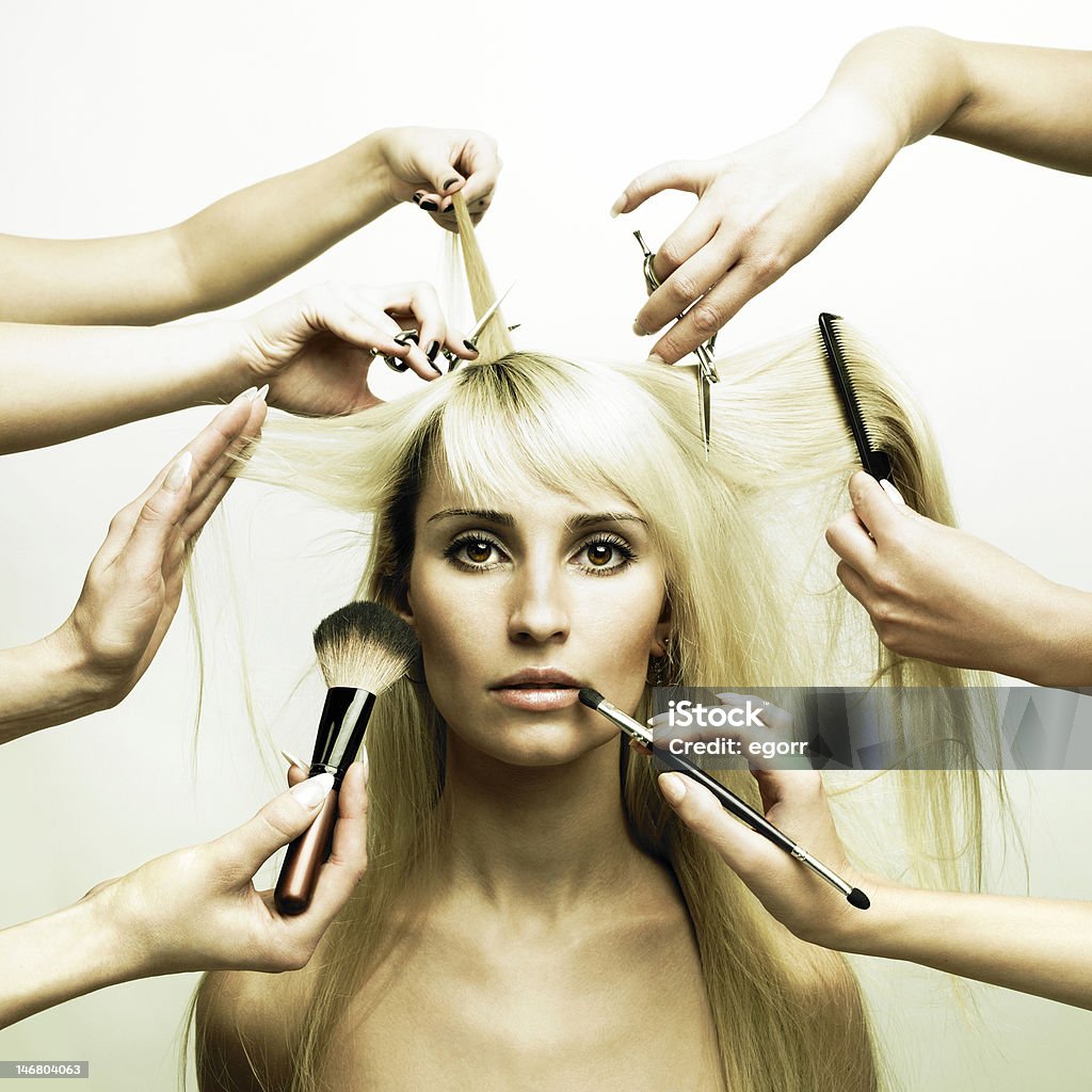 Hands of stylists working on a young blonde woman Woman in a beauty salon. Conceptual photo Hair Salon Stock Photo
