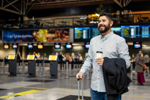 istock Businessman walking at airport with coffee 1468040821