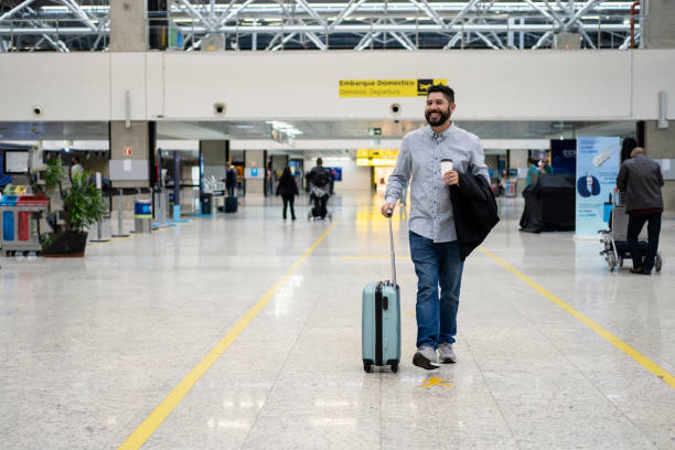 istock Businessman walking at airport with coffee 1468040835