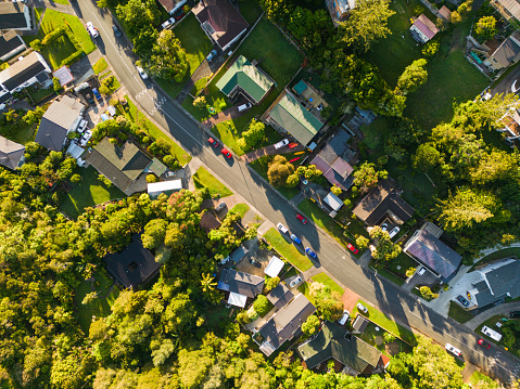 Overhead view of residential houses in a small suburb of Auckland during sunset.