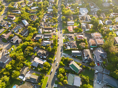 Overhead view of residential houses in a small suburb of Auckland during sunset.