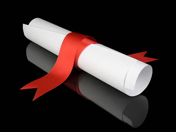 istock Diploma with red ribbon against black background 146804291