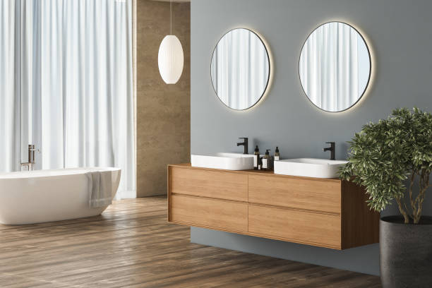 istock Modern bathroom interior with blue and beige background, parquet flooring, white bathtub, sink, plant, side view. Minimalist bathroom with modern furniture. 3D rendering 1468043510