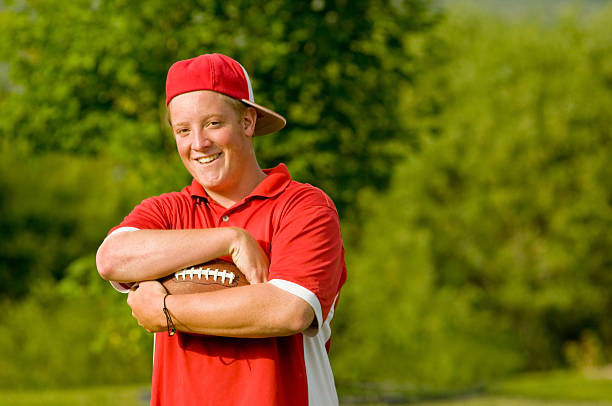 istock Handsome young man posing with football 146804679