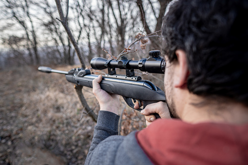 the hunter takes aim through the optical sight
