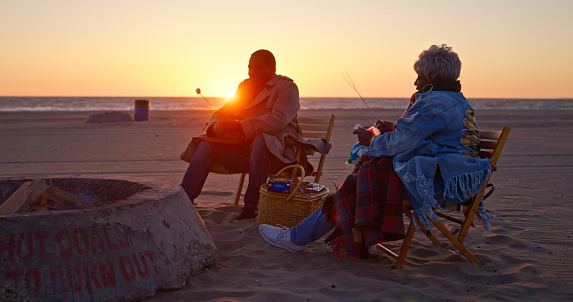 An African-American senior couple enjoying an evening together on the beach.