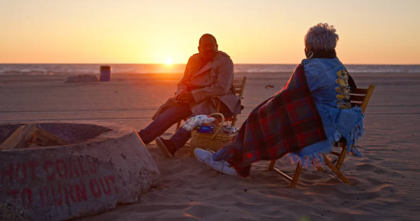 An African-American senior couple enjoying an evening together on the beach.