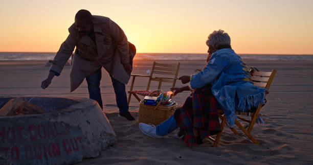 An African-American senior couple enjoying an evening together on the beach.
