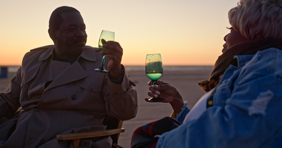 An African-American senior couple enjoying an evening together on the beach.
