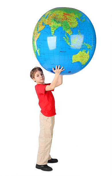 istock Boy holding big inflatable globe over his head side view 146805905