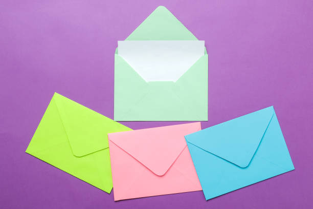 istock A multi-colored envelope with a blank for an inscription on a bright trendy lilac background. top view 1468061491