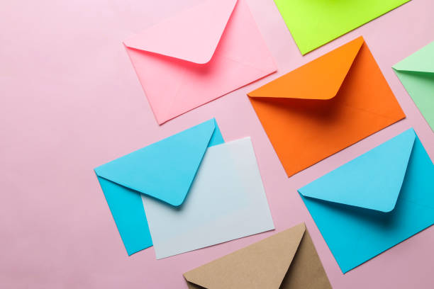 istock Multicolored envelope with blank for text on a bright trendy pink background. free space. top view. 1468061517