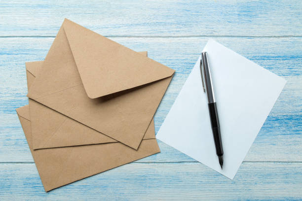 istock craft envelopes with blank for text on a blue wooden table. top view 1468061536