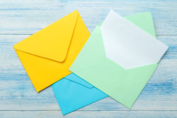 istock Multicolored envelopes with a blank for the text on a blue wooden table. top view 1468061538