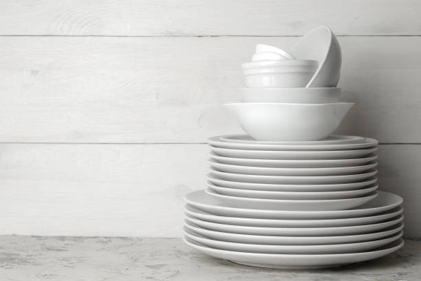 istock A stack of dishes. tableware on a light concrete background. dishes for serving the table. white plates and bowls in a stack. space for text 1468061564