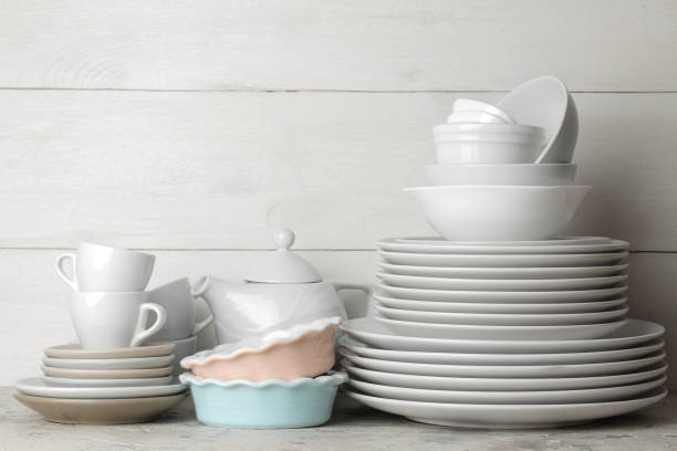 istock a lot of different dishes. Dinnerware. on a light concrete background. dishes for serving the table. various plates, bowls, and cups. 1468061578
