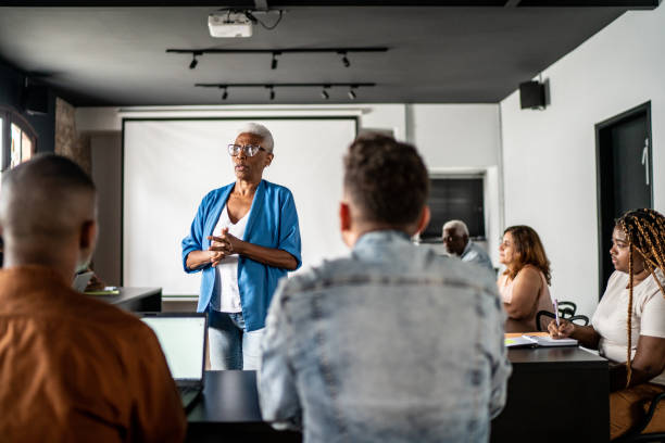 istock Senior woman teaching in a classroom or seminar 1468063326