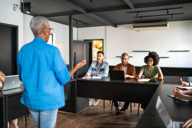 istock Senior woman teaching in a classroom or seminar 1468063821