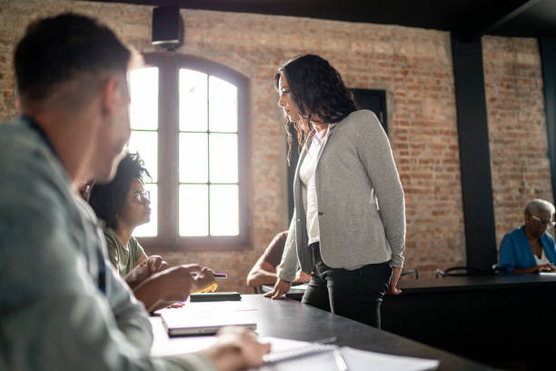 istock Transgender woman helping student in a classroom 1468064597