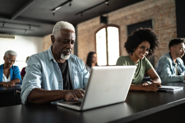 istock Senior man using laptop in the a seminar 1468065850