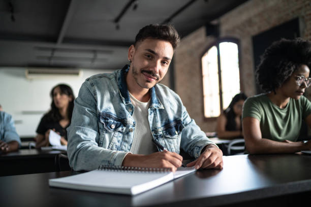 portrait of a mid adult man in the classroom - built structure education school education building imagens e fotografias de stock