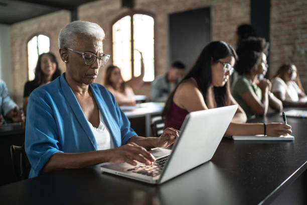 istock Senior woman using laptop in the classroom or seminar 1468066838
