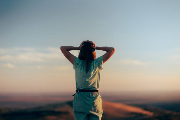 Traveler feeling disoriented and lost on a mountain top