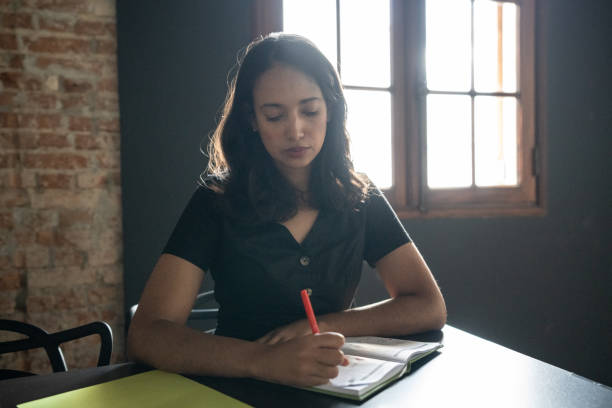 istock Mid adult woman taking notes during class or seminar 1468068606